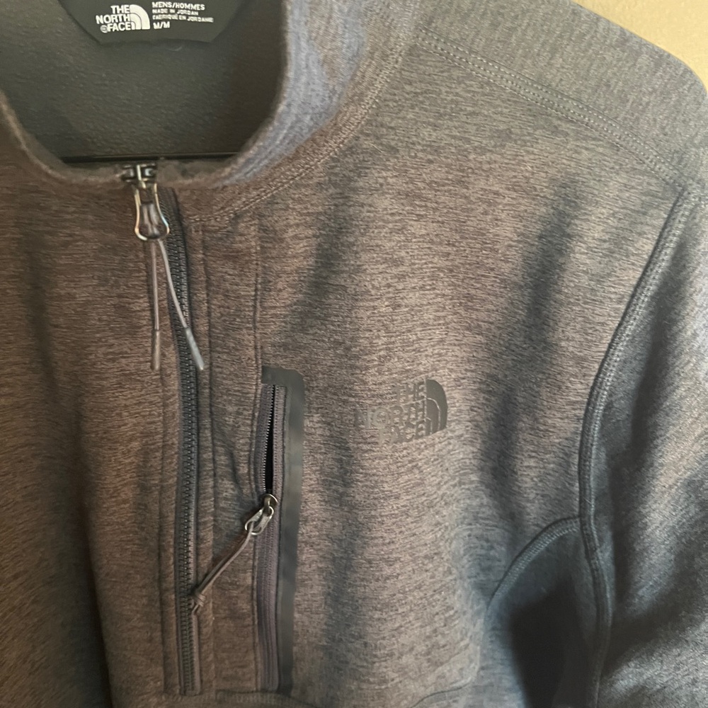 The North Face Men’s 1/4 zip fleece pullover size Medium in Charcoal color.